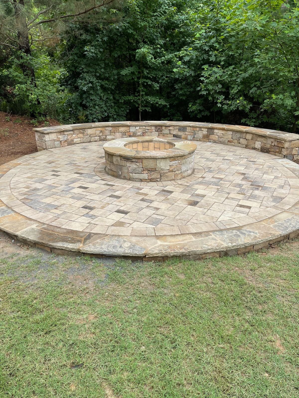Circular stone patio with fire pit & seat wall