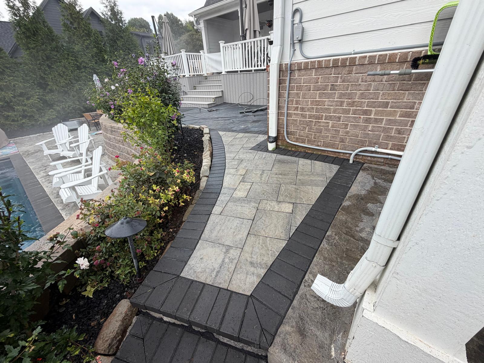 Paver walkway connecting patio to side yard