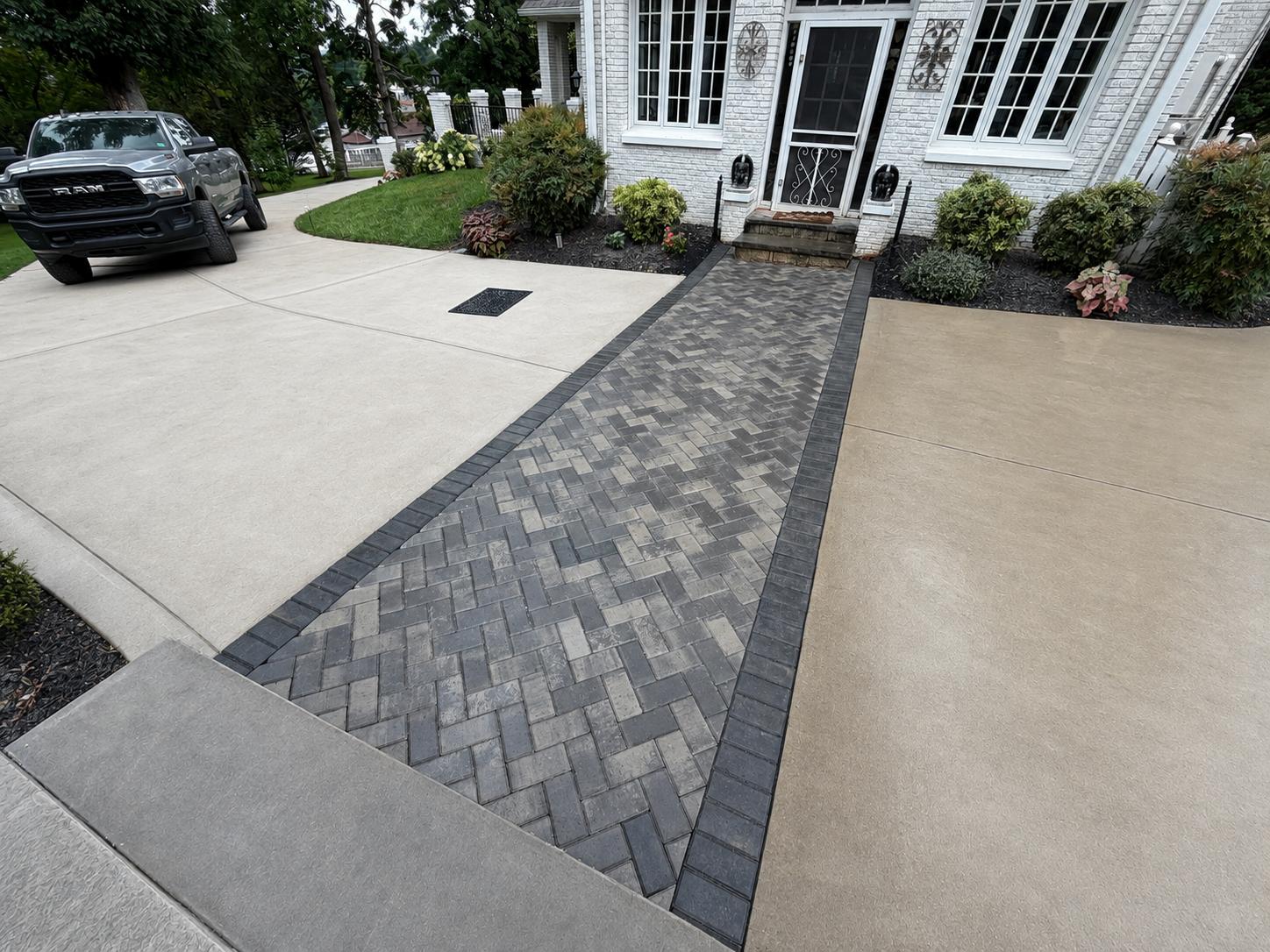 Herringbone paver entry walk with charcoal soldier border